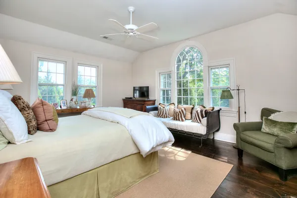 a bedroom with a large bed and a large window