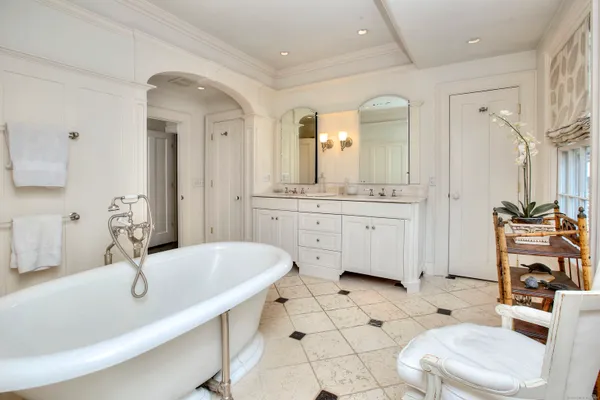 a bathroom with a granite countertop sink mirror and bathtub