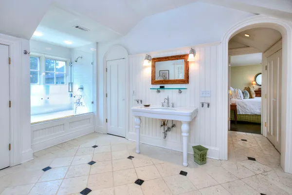 a spacious bathroom with a sink a mirror and a bathtub