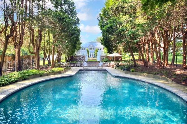 a view of yard with swimming pool and sitting area
