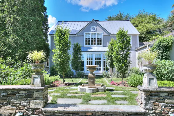 a front view of a house with garden