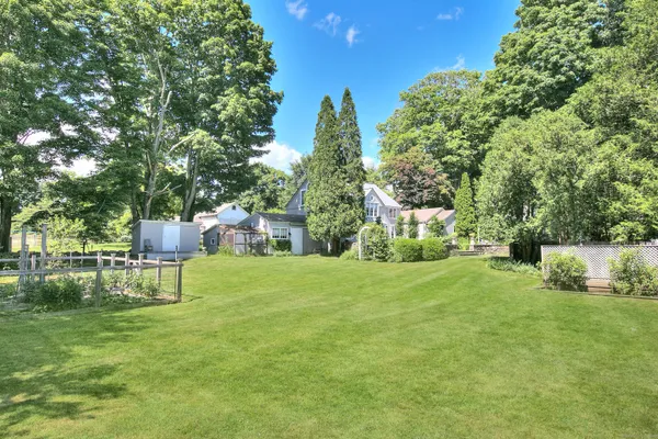 a view of a house with a yard and sitting area