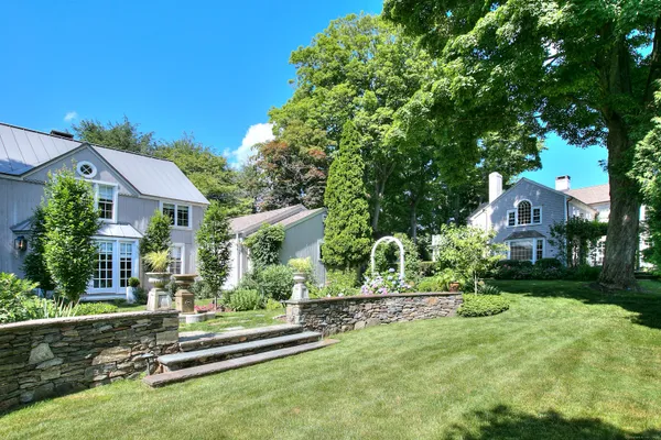 a front view of a house with a yard table and chairs