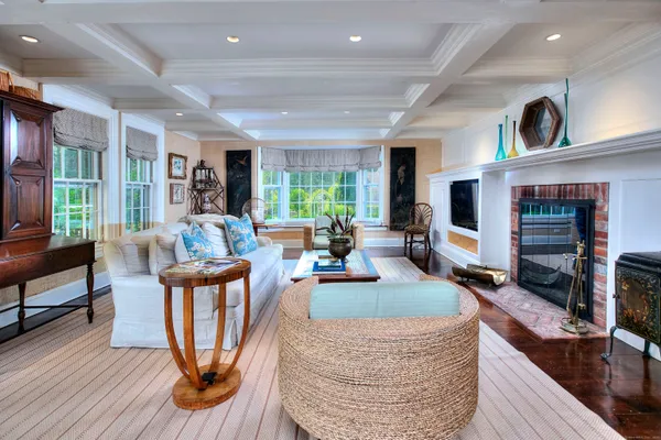 a living room with fireplace furniture and a wooden floor