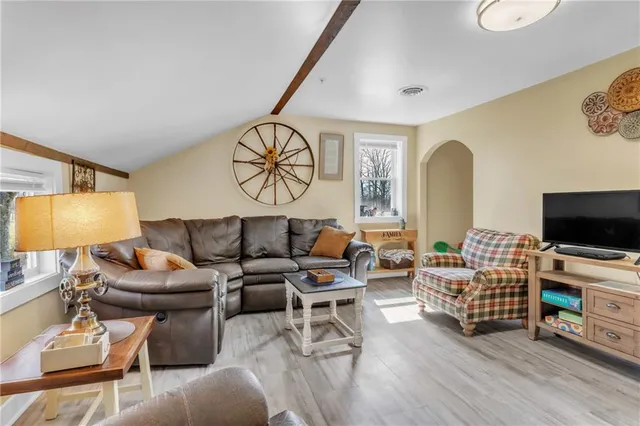 a living room with furniture and wooden floor