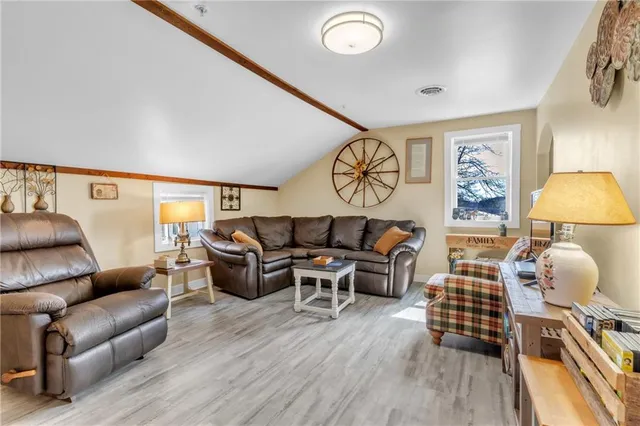 a kitchen with stainless steel appliances kitchen island granite countertop a stove a sink and a refrigerator with wooden floor