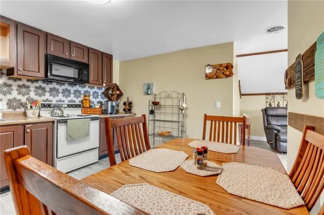 a dining room with furniture and wooden floor