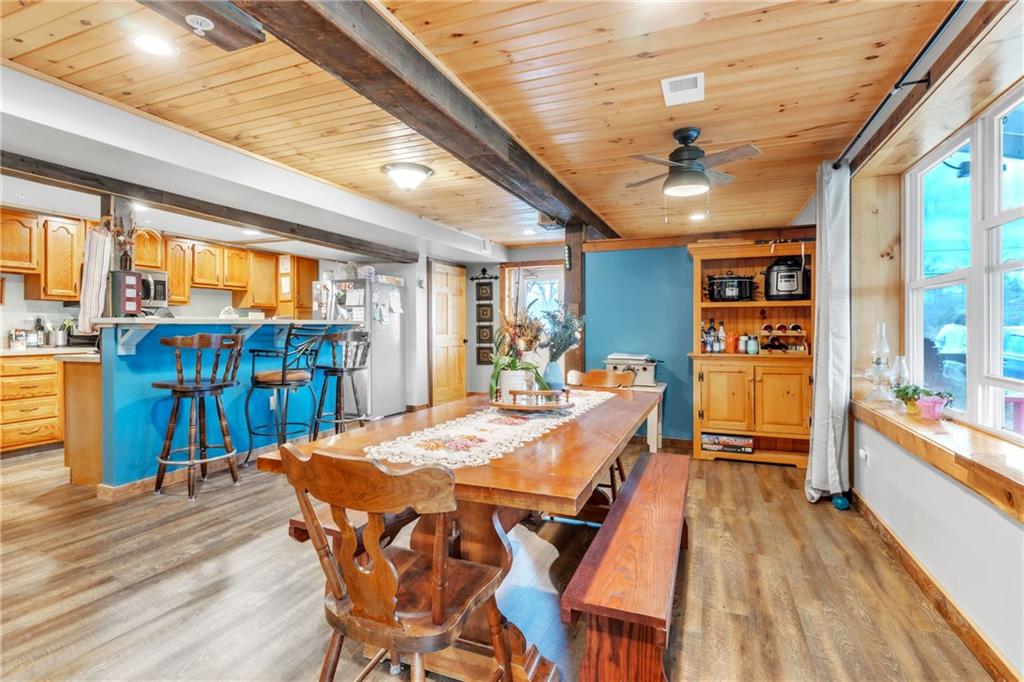 36044 Highway 66 Crown, PA 16233 - Photo 9 of 48 a view of a dining room with furniture window and wooden floor