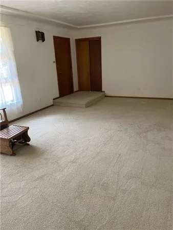 a view of an empty room and a window