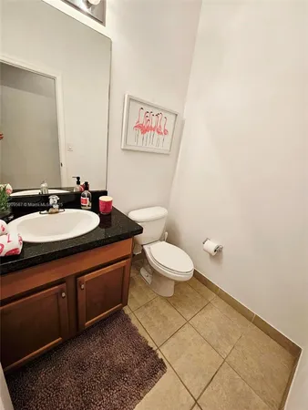 a bathroom with a sink mirror vanity and toilet