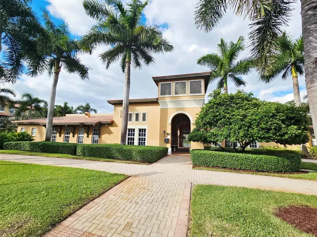 a front view of a house with a garden and yard