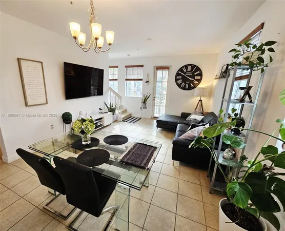 a living room with furniture potted plant and a window