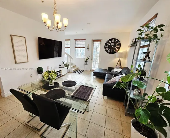 a living room with furniture potted plant and a window