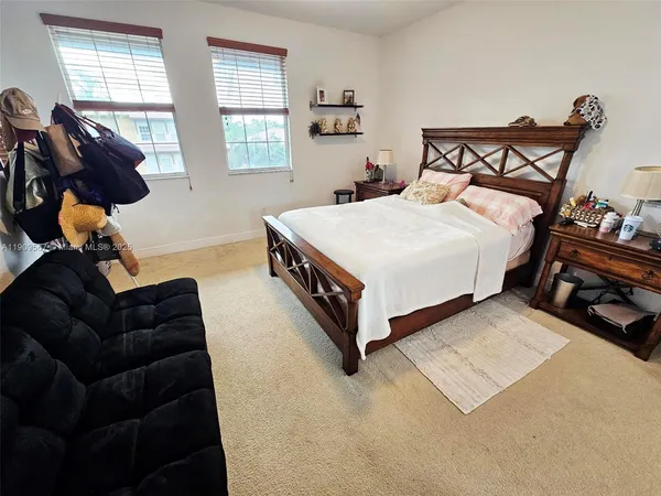 a spacious bedroom with a bed and window