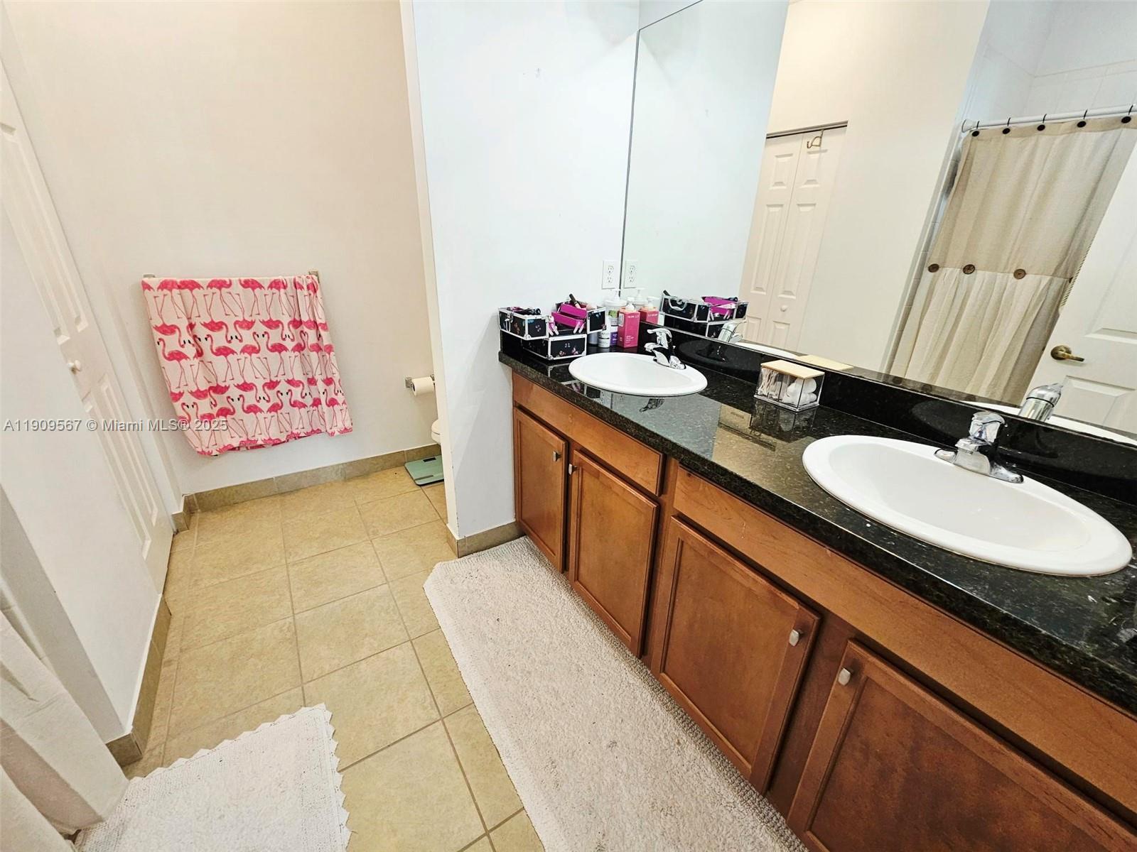 809 Southwest 147th Avenue, Unit 1401 Pembroke Pines, FL 33027 - Photo 8 of 19 a bathroom with a granite countertop sink a mirror and a bathtub