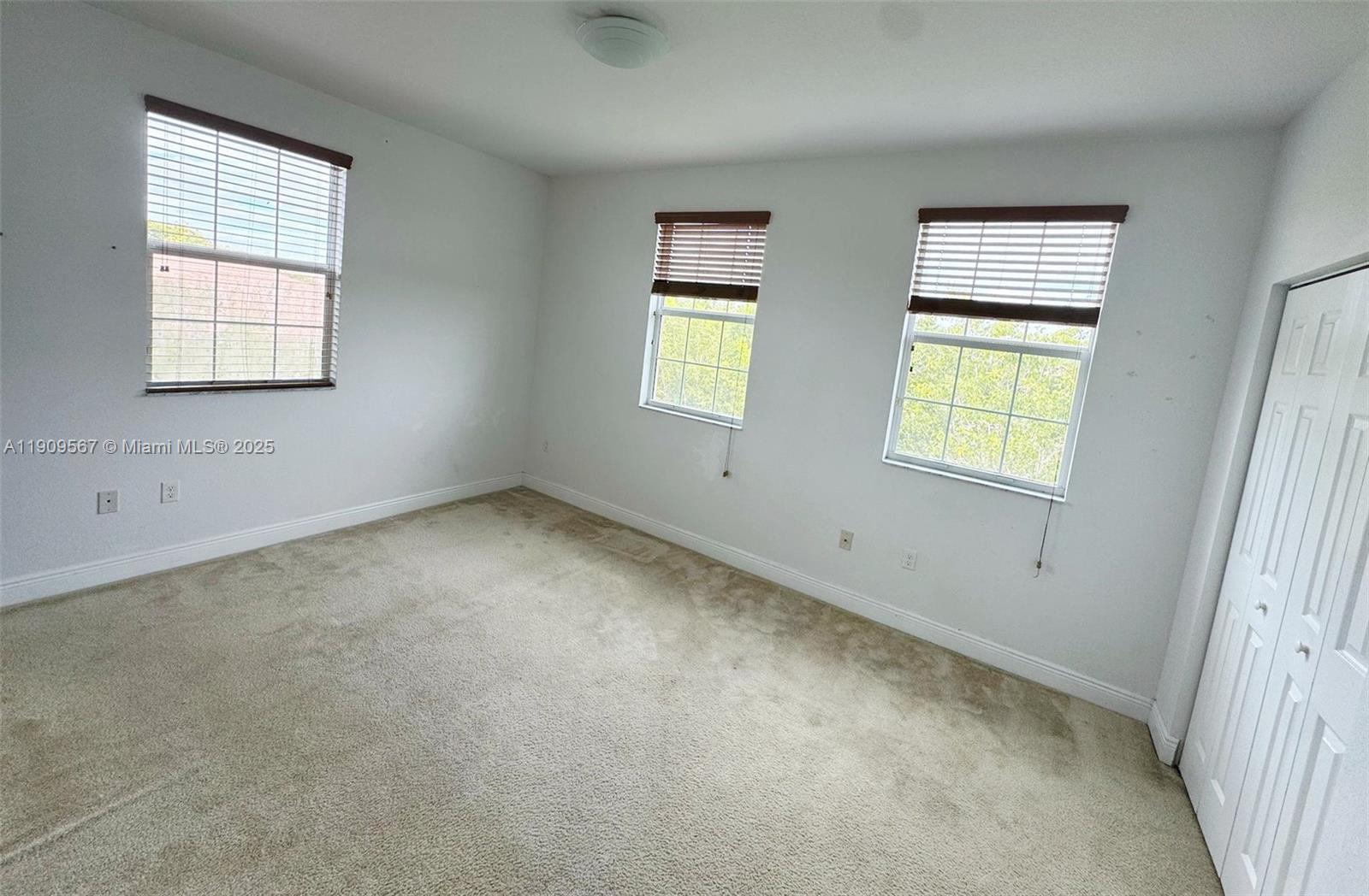 809 Southwest 147th Avenue, Unit 1401 Pembroke Pines, FL 33027 - Photo 9 of 19 an empty room with windows