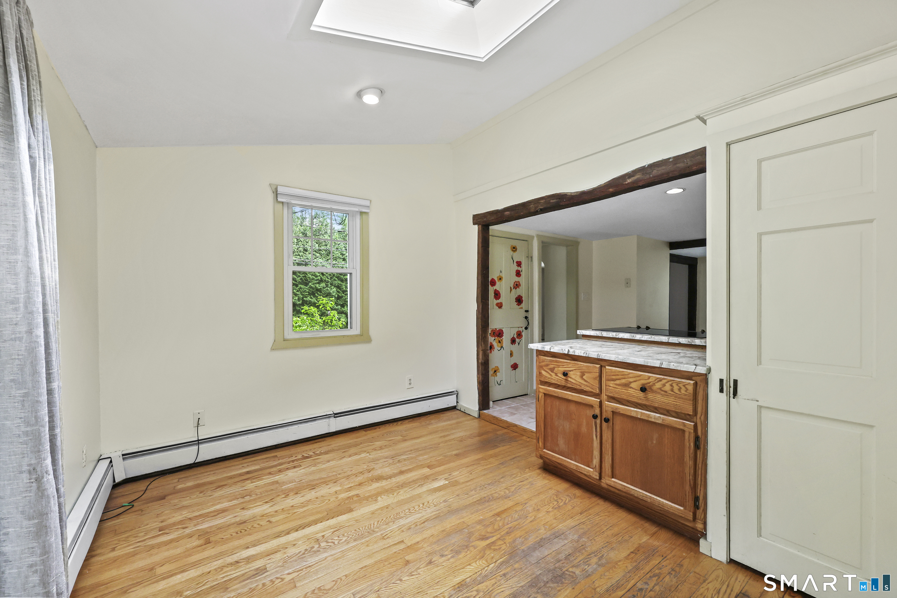 917 Hopewell Road Glastonbury, CT 06033 - Photo 10 of 39 a view of an empty room with window and wooden floor