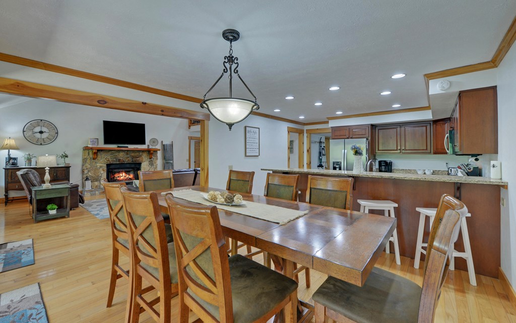 321 Call-Wright Road Ellijay, GA 30540 - Photo 11 of 92 a view of a dining room with furniture a fireplace and wooden floor