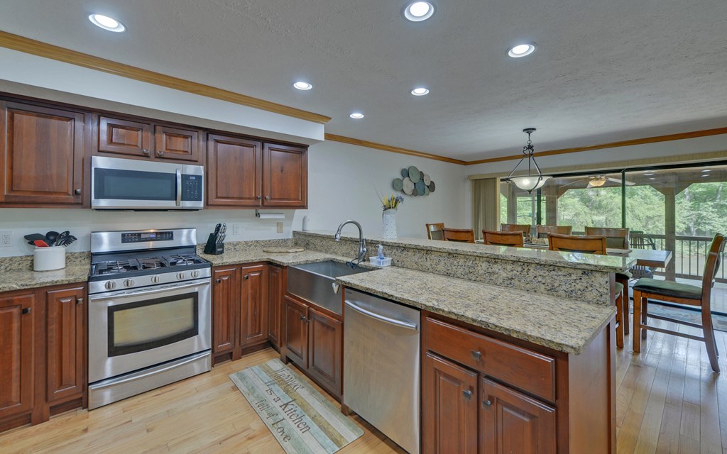 321 Call-Wright Road Ellijay, GA 30540 - Photo 13 of 92 a kitchen with stainless steel appliances granite countertop a stove a sink and a microwave