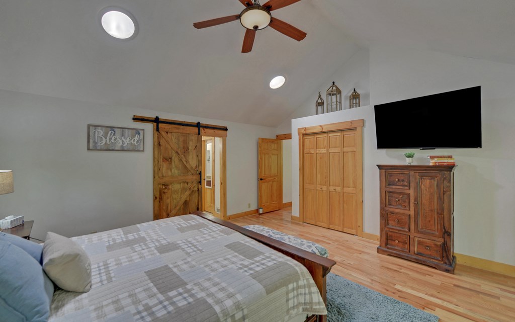 321 Call-Wright Road Ellijay, GA 30540 - Photo 16 of 92 a bedroom with a bed and a flat screen tv