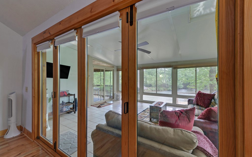321 Call-Wright Road Ellijay, GA 30540 - Photo 18 of 92 a living room with furniture and a floor to ceiling window