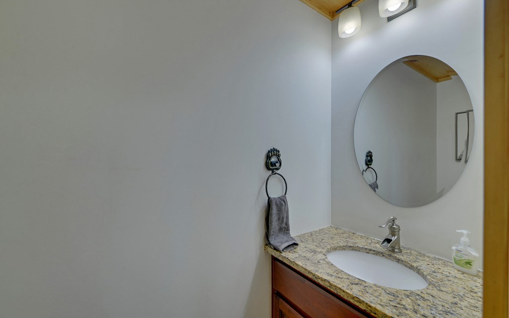 321 Call-Wright Road Ellijay, GA 30540 - Photo 21 of 92 a bathroom with a granite countertop sink a mirror and vanity