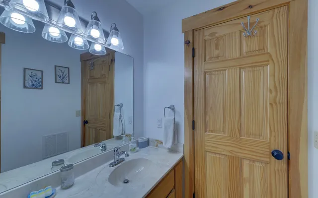 a view of a house with a yard and large tree