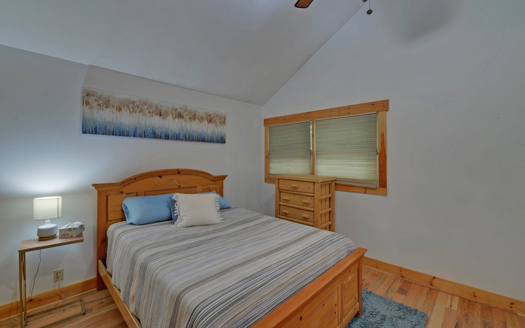 321 Call-Wright Road Ellijay, GA 30540 - Photo 32 of 92 a bedroom with a bed and wooden floor