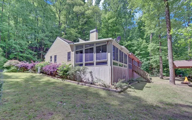 a front view of a house with a garden and plants