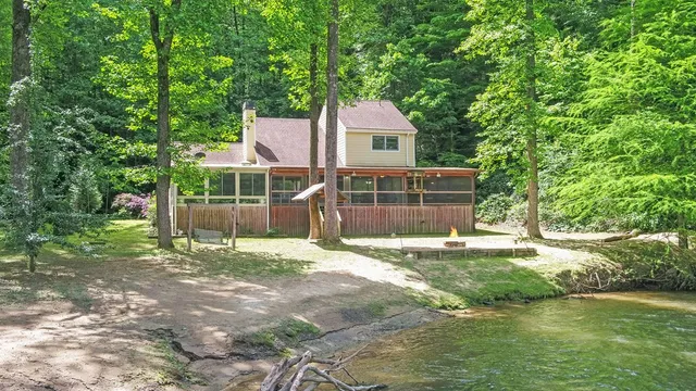 a view of a park with bench and trees in the background