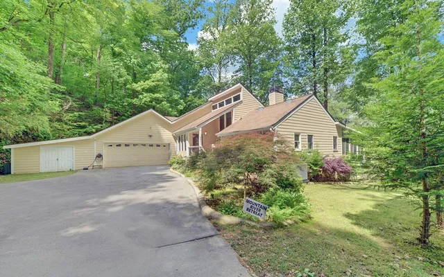 an aerial view of a house with a yard and garden space