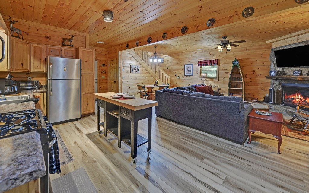 321 Call-Wright Road Ellijay, GA 30540 - Photo 58 of 92 a living room with furniture a flat screen tv and kitchen view