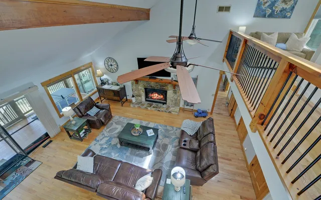 a view of a dining room with furniture a fireplace and wooden floor