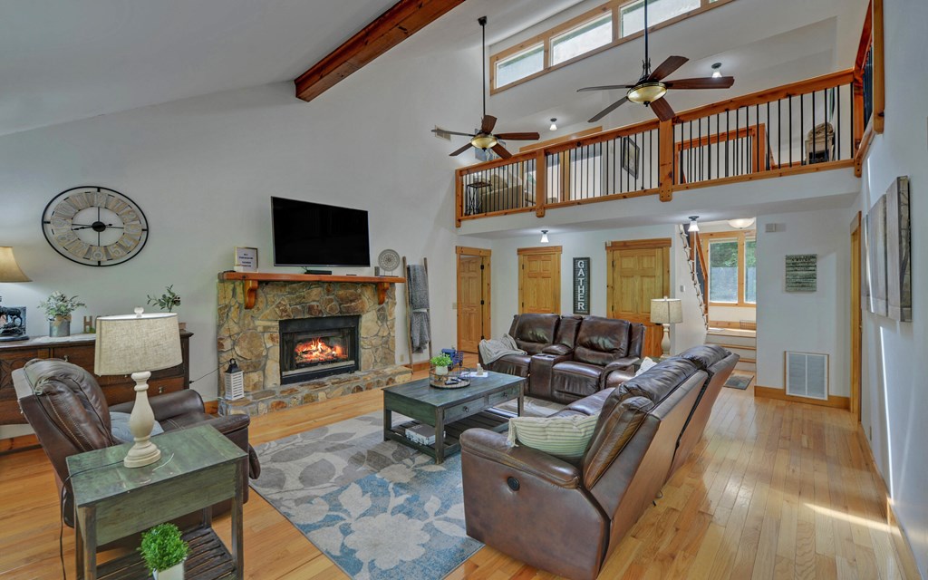 321 Call-Wright Road Ellijay, GA 30540 - Photo 8 of 92 a living room with furniture a fireplace and a flat screen tv