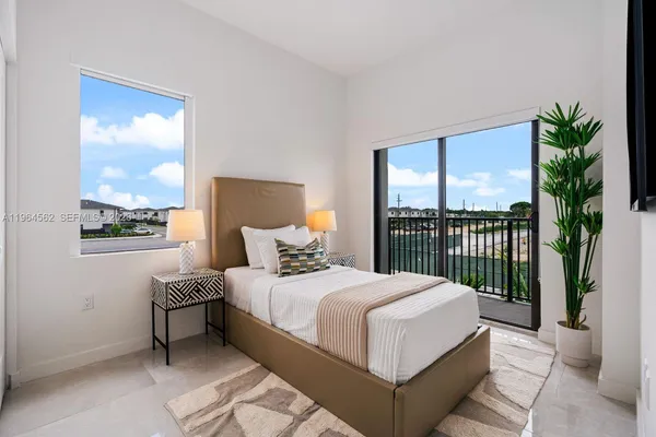 a bedroom with a large bed and a window