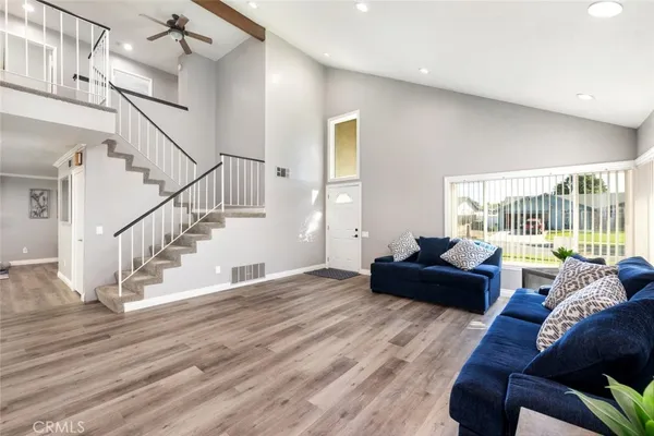 a living room with furniture and wooden floor