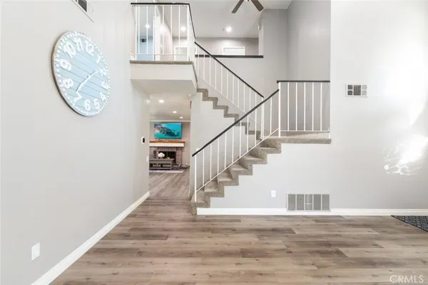 a view of entryway and hall with wooden floor