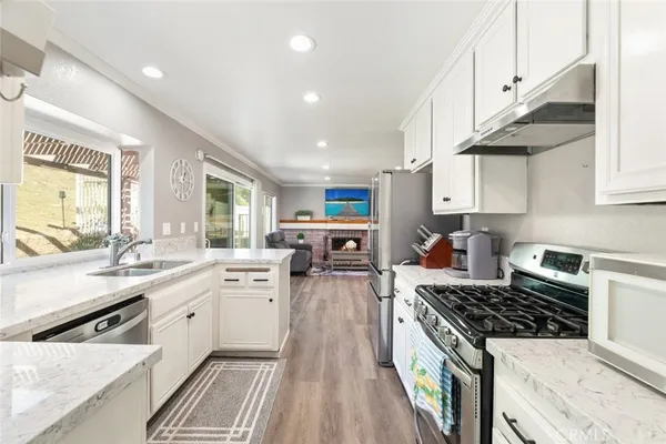 a large kitchen with stainless steel appliances granite countertop a stove and a sink