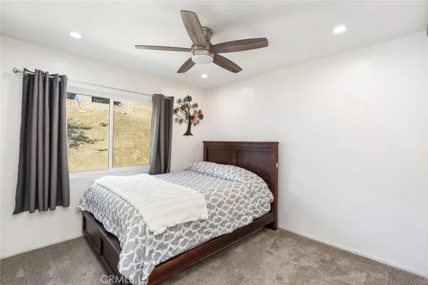 a bedroom with a bed and window