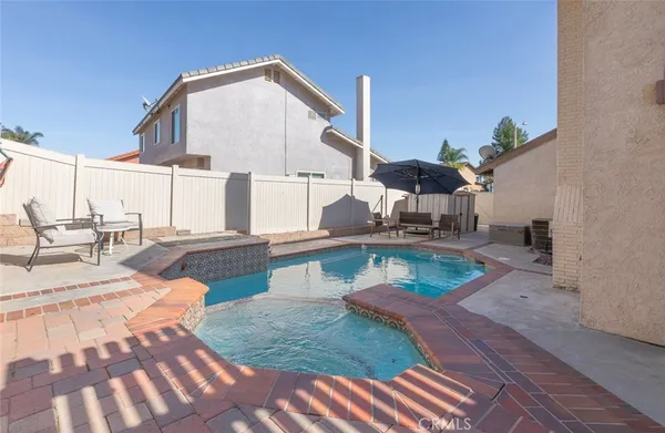 a backyard of a house with table and chairs