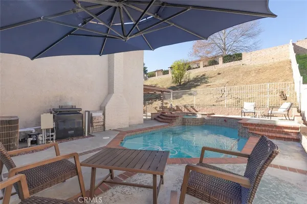 a view of a swimming pool with a lounge chair