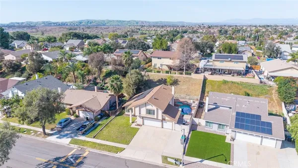 an aerial view of a house with a swimming pool