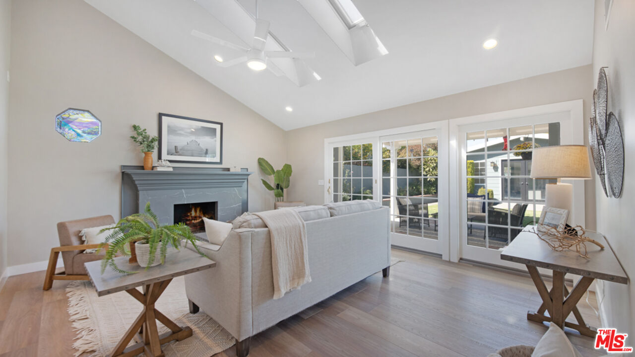 5601 Middlecoff Drive Huntington Beach, CA 92649 - Photo 1 of 49 a living room with furniture a fireplace and a floor to ceiling window
