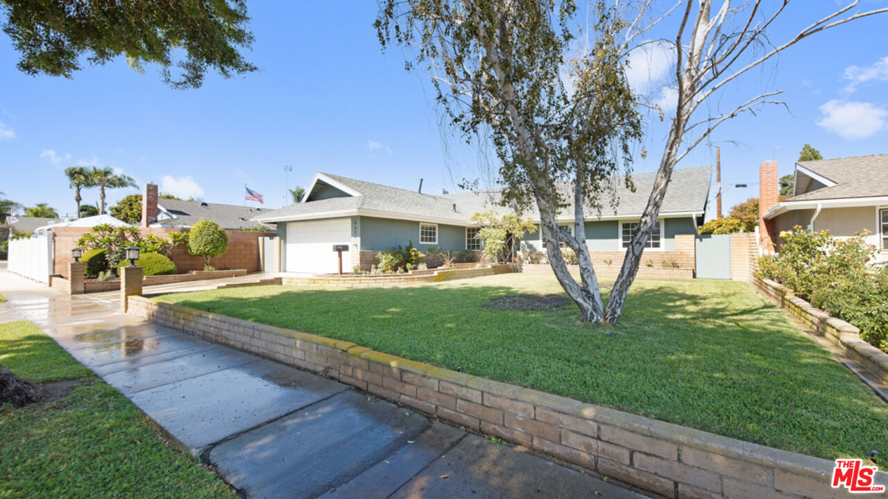 5601 Middlecoff Drive Huntington Beach, CA 92649 - Photo 11 of 49 a front view of a house with a yard and trees