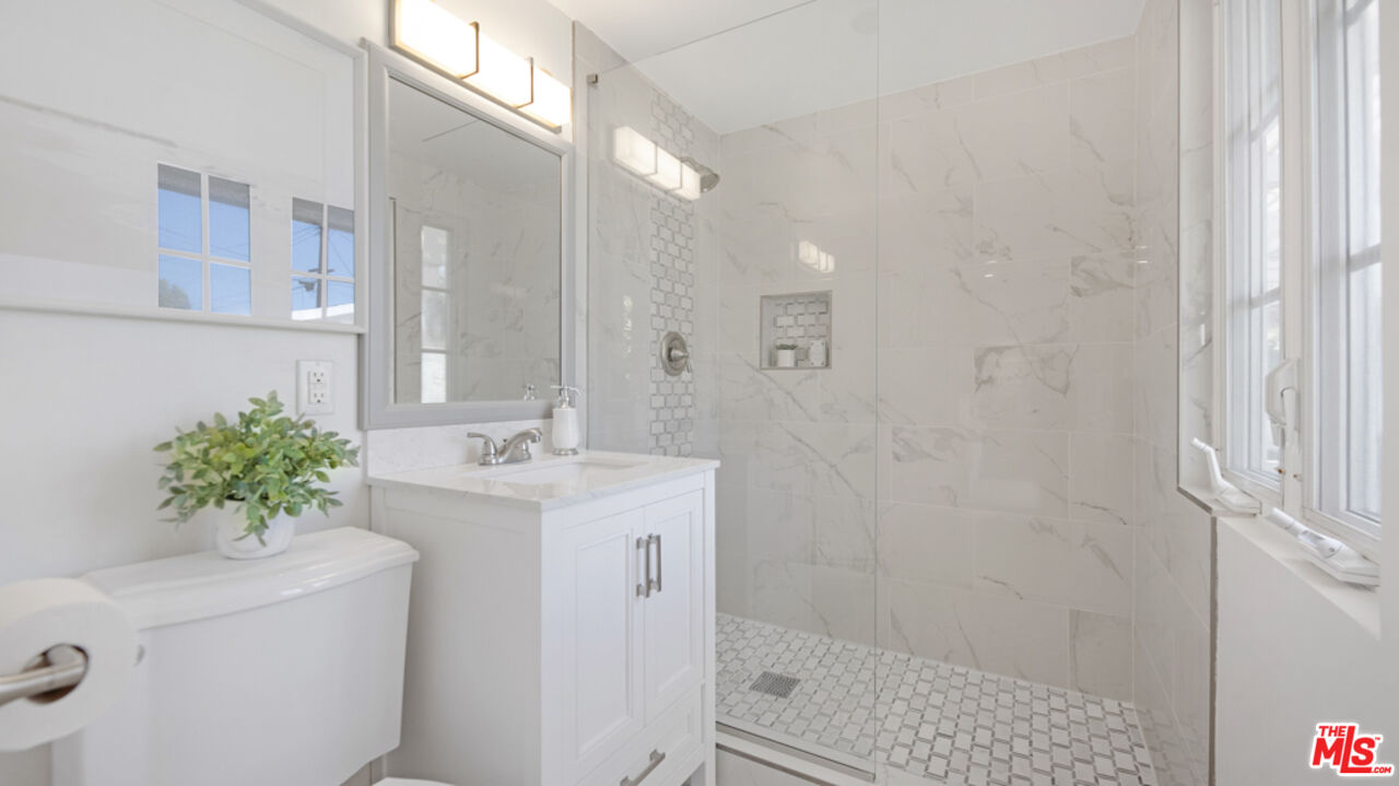 5601 Middlecoff Drive Huntington Beach, CA 92649 - Photo 18 of 49 a bathroom with a sink a vanity and a mirror