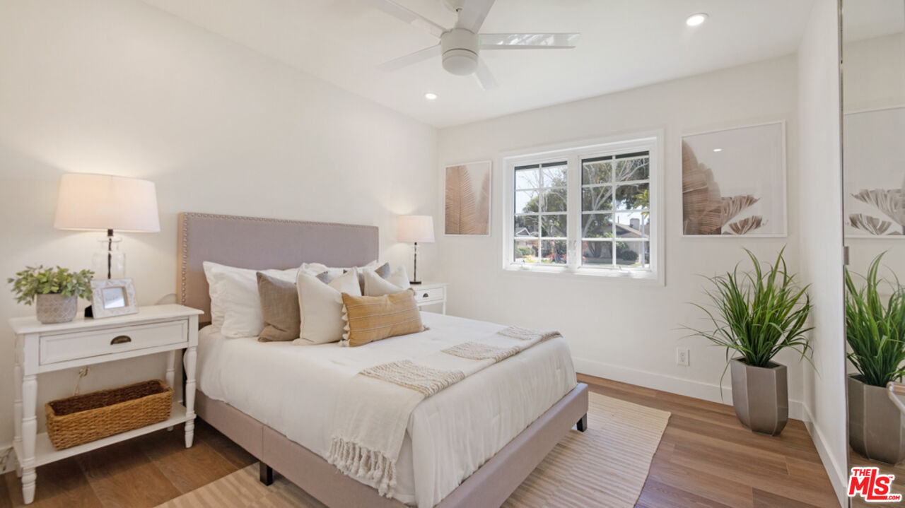 5601 Middlecoff Drive Huntington Beach, CA 92649 - Photo 21 of 49 a bedroom with a large bed and a potted plant