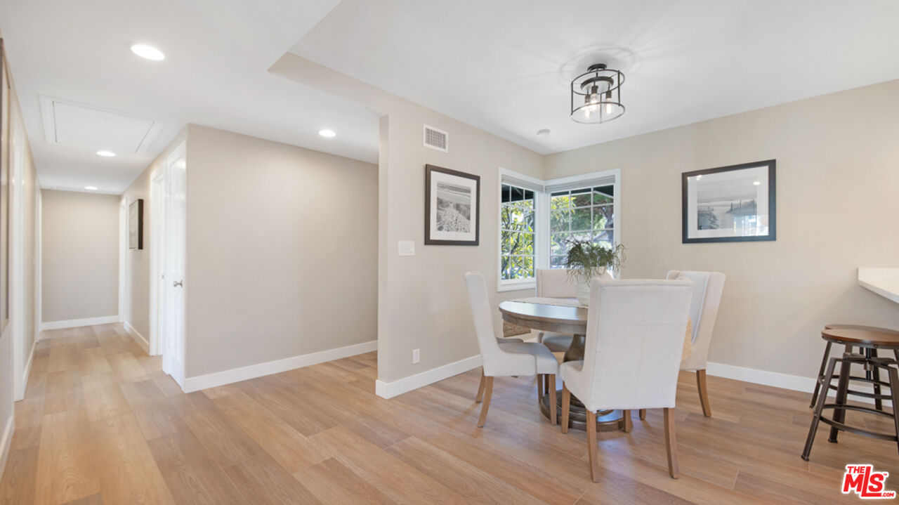 5601 Middlecoff Drive Huntington Beach, CA 92649 - Photo 24 of 49 a view of a dining room with furniture window and wooden floor