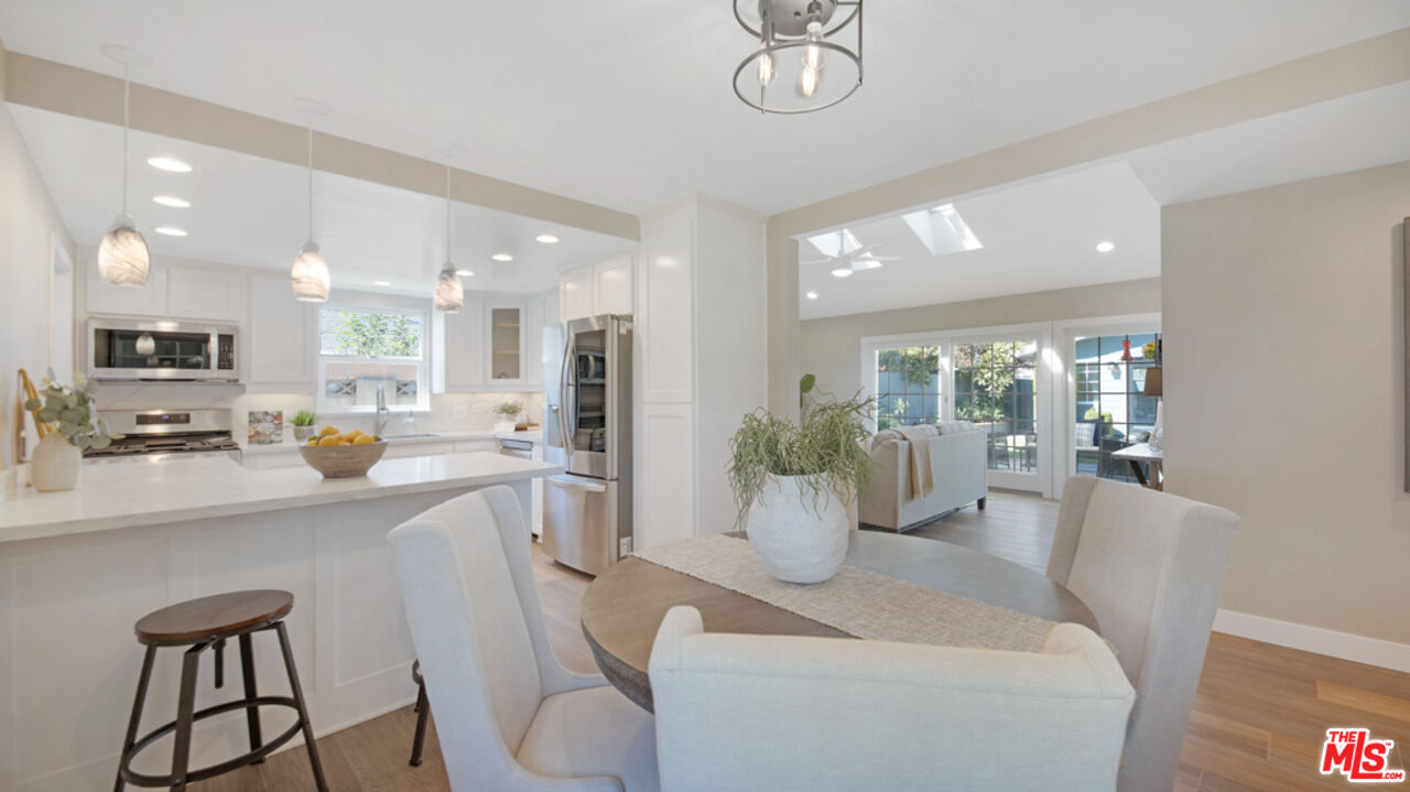 5601 Middlecoff Drive Huntington Beach, CA 92649 - Photo 26 of 49 a view of a dining room and livingroom with furniture wooden floor and a chandelier