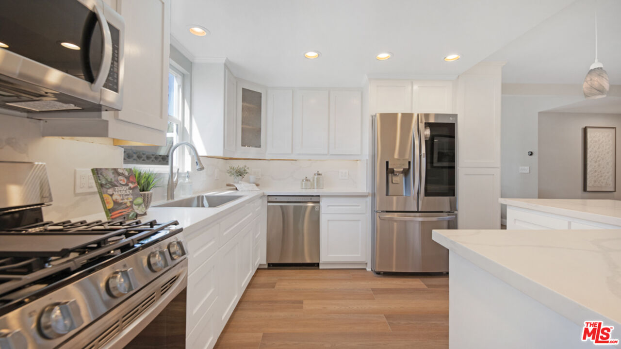5601 Middlecoff Drive Huntington Beach, CA 92649 - Photo 30 of 49 a kitchen with a stove and a refrigerator