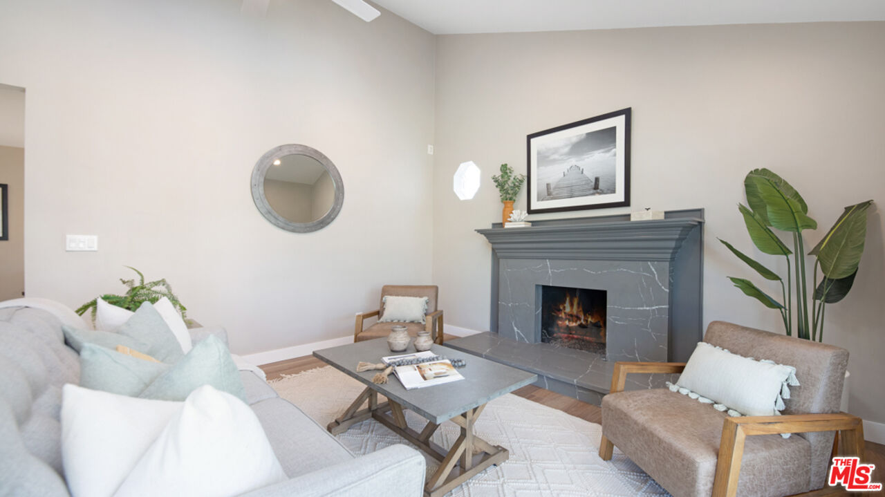 5601 Middlecoff Drive Huntington Beach, CA 92649 - Photo 33 of 49 a living room with furniture a fireplace and wall paintings